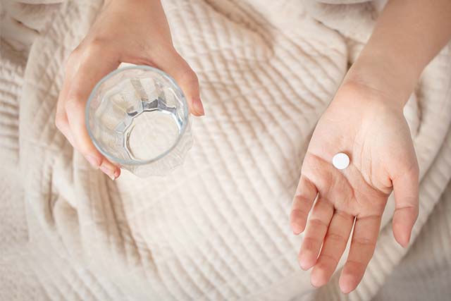 persona tomando analgésico